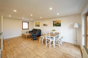 a living room with a table and chairs and a couch at Ferienhaus am Gurkenradweg in Stennewitz