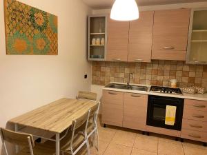 a kitchen with a table and a stove and a sink at Confort home in Rende +20 photos