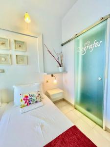 a room with a bed and a glass door at Villa Zografos in Iraklia