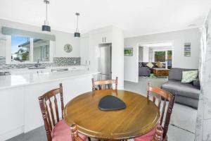 a kitchen and dining room with a wooden table and chairs at Home away from home! in Hamilton