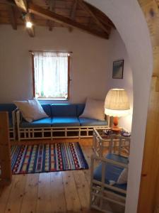 a living room with a blue couch and a window at Villa in Skiathos in Kechria