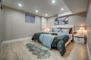 a bedroom with a large bed and a rug at Vacation Suite in Pickering in Pickering