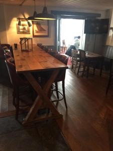 a large wooden table in a room with chairs at Dunstan House in Burnham on Sea