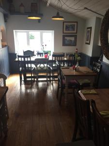 a dining room with a table and chairs at Dunstan House in Burnham on Sea