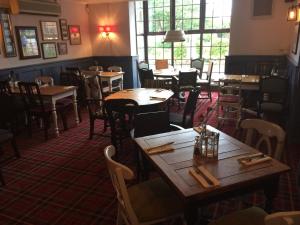 a restaurant with tables and chairs in a room at Dunstan House in Burnham on Sea