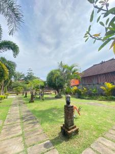 a park with a street light in the grass at Padang-Padang Sari Homestay in Uluwatu