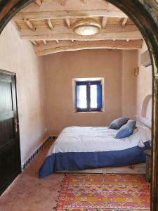 um quarto com uma cama grande num quarto em Bab El Atlas em El Kelaa des Mgouna