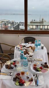 a table with plates of food and water bottles at Terrace Guesthouse in Istanbul +55 photos
