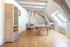a dining room with a table and chairs in a attic at Appartement dans le vieux Châteauroux in Châteauroux