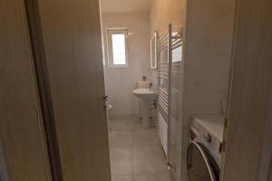 a bathroom with a sink and a washing machine at Villa Fortuna in Chania