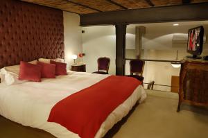 a bedroom with a large bed with red pillows at Poetry Building Recoleta in Buenos Aires