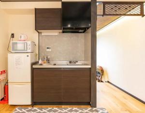 a kitchen with a sink and a refrigerator at Kyoto-Toji house in Kyoto