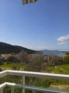a view of the ocean from a balcony of a house at Apartman Milica in Vrgada