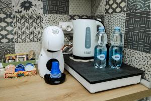 a kitchen counter with a blender and bottles of water at Terra Mia Suite in Catania