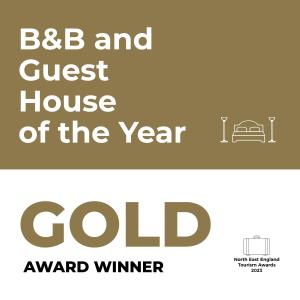 a sign that reads bb and guest house of the year gold at Market Cross Guest House in Belford