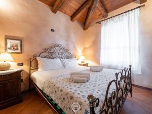a bedroom with a bed in a room with a window at Seafront Rustic Hideaway in San Vero Milis