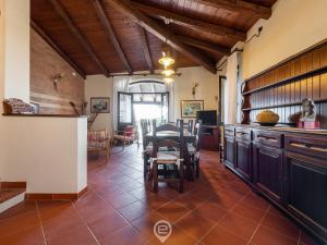 a kitchen and dining room with a table and chairs at Seafront Rustic Hideaway in San Vero Milis