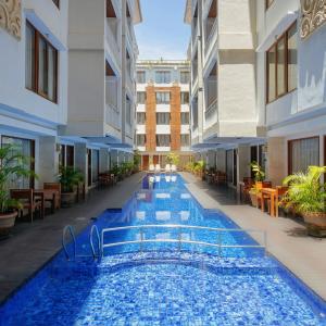 an empty pool in the middle of a building at The Sun Hotel & Spa Legian - CHSE Certified in Legian