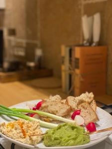 un piatto di alimenti con verdure e guacamole su un tavolo di Nook. The Design Apartment a Târgu-Mureş