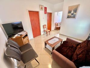 a living room with a couch and a tv at Apartments Mare in Dramalj