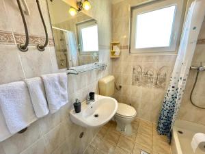 a bathroom with a sink and a toilet and a mirror at Apartments Mare in Dramalj +68 photos