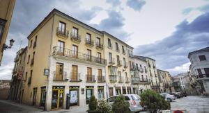 a large yellow building with balconies on a street at Hostal Plaza in Ciudad-Rodrigo