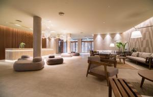 a living room with a couch and a table and chairs at AKASHA Beach Hotel & Spa in Hersonissos