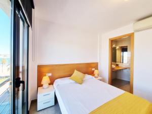 a bedroom with a white bed and a window at Apartamento Medusa in L'Escala