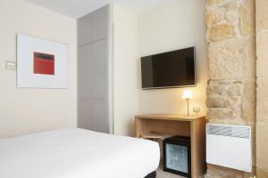 TV a/nebo společenská místnost v ubytování Welcome Gros Hotel