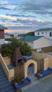 a view of a balcony with a brick fireplace at The Edge in Franskraal
