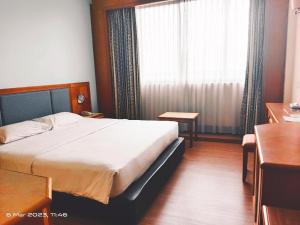 Voodi või voodid majutusasutuse The Paramount Hotel Sibu toas