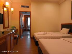 Voodi või voodid majutusasutuse The Paramount Hotel Sibu toas