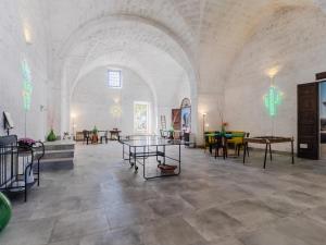 a large room with tables and chairs in a building at Salento 4 Stars - Blue & Yellow in Squinzano