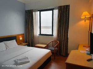 Voodi või voodid majutusasutuse The Paramount Hotel Sibu toas