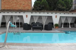 a patio with a pool and chairs and a table at Hotel Salomé in Calafell