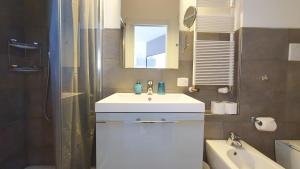 a bathroom with a sink and a shower and a tub at Apartment Giotto Eremitani in Padova