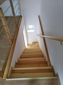 a staircase in a house with wooden floors at Siedlisko 14 Chata in Mikołajki