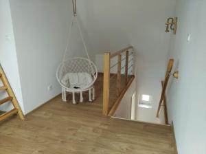 a room with a swinging chair and a staircase at Siedlisko 14 Chata in Mikołajki