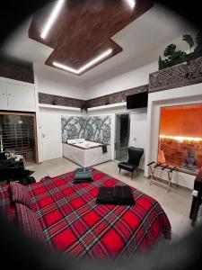 a bedroom with a large red bed and a fireplace at Terra Mia Suite in Catania