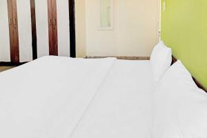Ein Bett oder Betten in einem Zimmer der Unterkunft SPOT ON Ganesh Guest House