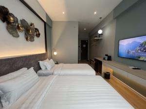 Postel nebo postele na pokoji v ubytování FUHOTEL