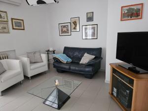 uma sala de estar com um sofá e uma televisão em B&B Interno 14 em Taranto