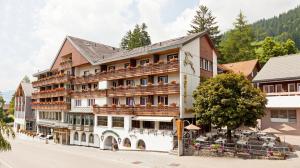 a hotel in the middle of a street at Hotel Hirschen Wildhaus in Wildhaus