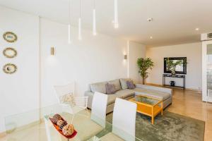 a living room with a couch and a table at VilamouraSun Aquamar 410 Vista marina in Vilamoura