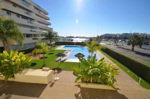 a swimming pool in front of a building at Marina Vilamoura Aquamar 012 by VilamouraSun in Vilamoura