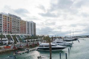 a group of boats docked in a marina with buildings at Boat View Marina Plaza By VilamouraSun in Vilamoura