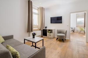 a living room with a couch and a table at Parkhotel Wangerooge in Wangerooge