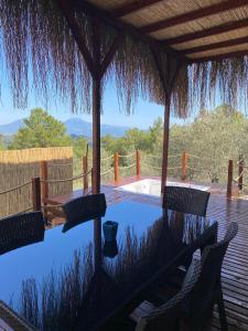 a patio with a table and chairs on a deck at Lovin Göcek & Tiny House Lykia in Kertmeç
