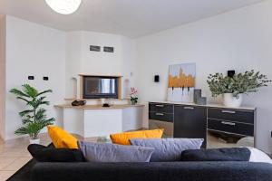 uma sala de estar com um sofá e uma cozinha em Casa a Telti by Wonderful Italy em Telti