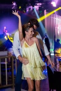 a man and a woman dancing on a dance floor at Lopesan Costa Bávaro Resort, Spa & Casino in Punta Cana